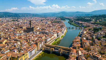An aerial view of Florence, Italy, captured by a drone, highlighting the city's stunning...