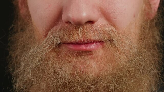 Make up artist making Disheveled blond beard for a man in theater with paint and glue, actors sfx cinema make up, close-up. Mens fashion, halloween style. making old guy.