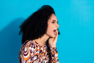 Photo of mad crazy woman wear stylish print clothes loud scream empty space isolated on blue color...