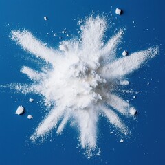 White Powder Exploding against Blue Background in Artistic Display