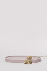 Beauty Cosmetics Product Presentation Stage made with Beige Oval Tray and Dry Summer Grass. Stylish Summer Background to Place Your Product. Vertical photography.