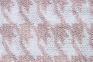 Texture of knitted fabric with pattern as background, top view