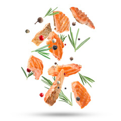 Delicious grilled salmon, rosemary and mix of peppers falling on white background