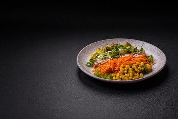 Fresh juicy salad with meat, mozzarella, carrots, lettuce, corn