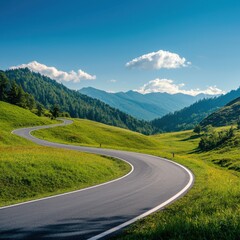 Fototapeta premium A scenic winding road through lush green hills and mountains under a bright blue sky, ideal for travel and nature enthusiasts.