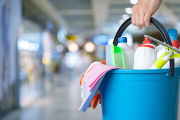 Management holding bucket with cleaning supplies .