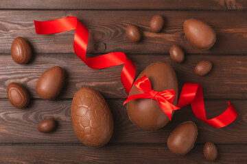 Easter chocolate egg on textured background. Easter celebration concept. Easter chocolate rabbit....