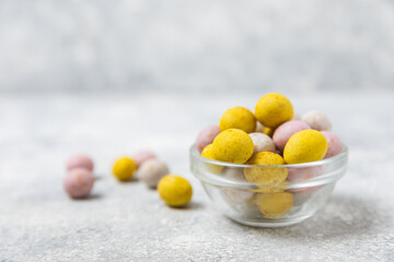 Easter chocolate egg on textured background. Easter celebration concept. Easter chocolate rabbit. Chocolate sweet eggs. Candies on textured wooden table. Space for text.Copy space. Gift. Banner.