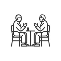 Two Men Sitting at a Table with a Cup in Front of Them