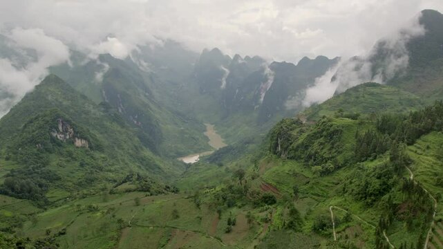Aerial view of tu san canyon and nho que river with lush rice terraces and majestic mountains, Meo Vac, Vietnam.
