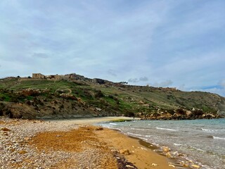 Beautiful sandy beach on the Coast of the island of Gozo, Malta. The Mediterranean Sea.