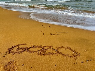 The word Gozo written in the sand on the seashore of Gozo island.
