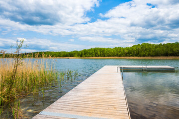 Naklejka premium Wooden pier on shore of Kamedul lake, Suwalski Landscape Park, Podlasie, Poland