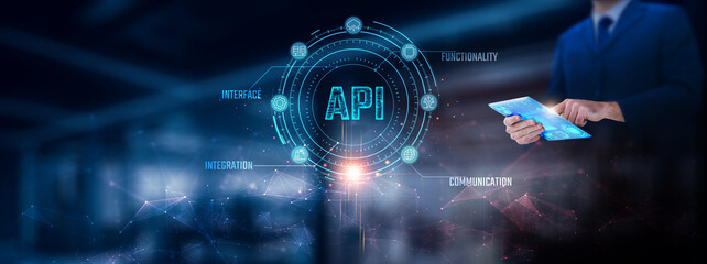 API: Businessman using tablet analyzing API record on tablet. Digital integration and network connection on modern virtual screen interface, data exchange, automation, technology and network.