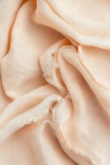 Close-up of a torn piece of silk fabric, showing a macro view with smooth texture and frayed edges.