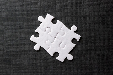 Four puzzle elements on black background. Abstract banner. Business or education concept