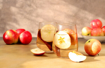 Apple cider with apple pieces, cinnamon, star anise or fermented drink and fresh apples. Autumn banner. Diet and weight loss concept. Healthy eating, body detoxification, apples help cleanse the body.