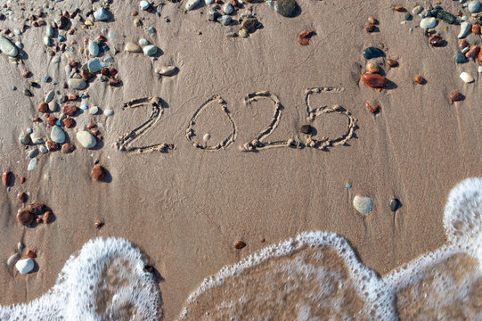 Message Year 2024 replaced by 2025 text written on beach sand background. Good bye 2024 hello to 2025 happy New Year coming concept. top view. Estonia