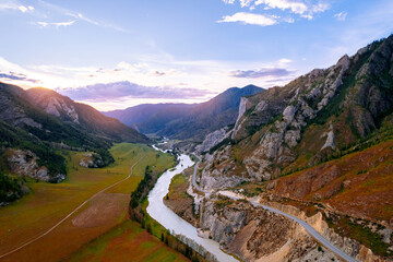 Sunset landscape Altai mountains white rock with green forest and winding river, aerial top view