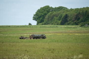 British army bae systems, Puch, Daimler, Pinzgauer High-Mobility All-Terrain 6x6 vehicle towing a 105mm Light Artillery Gun on a military exercise © Martin