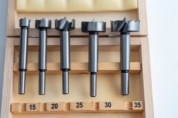 set of preciaion metal forstner bits for engineering and woodworking  in a wooden box with sizes in...