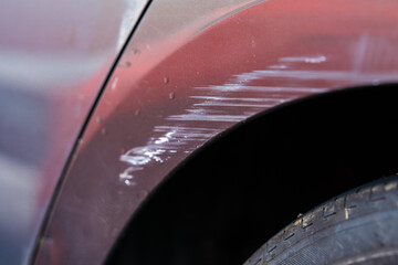 Obraz premium Scuff marks on the wheel arch of a grey hire car.