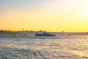 Obraz premium Istanbul view at sunset with cityscape of Istanbul and a ferry.