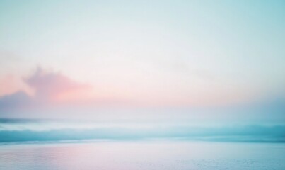 A blurry image of a beach with a cloudy sky in the background