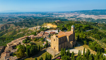 An aerial view of Le Balze di Volterra and the San Giusto Volterra in Tuscany, Italy, captured by a drone. Le Balze di Volterra is a dramatic and unique landscape of steep cliffs