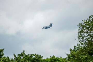 British RAF Airbus A400M large cargo plane on a military exercise, cloud background sky
