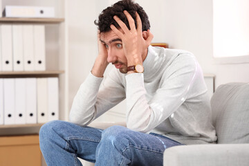 Young man having panic attack at home