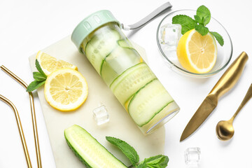 Sports bottle of lemonade with cucumber and mint on white background