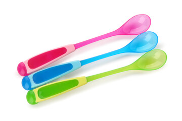 Colorful spoons for baby isolated on white background
