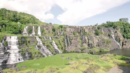 Aerial view of pongour falls surrounded by lush greenery and rock formations, Tan Thanh, Vietnam.