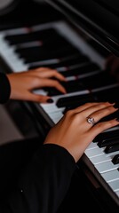 Obraz premium A woman's hand with a diamond ring on a piano keyboard