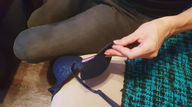 Footage of the woman with beautiful hands stitching or sewing delicate lingerie fabric. Craft