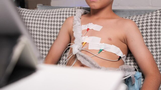 close-up of electrodes on boy's chest, heart diagnostics at home