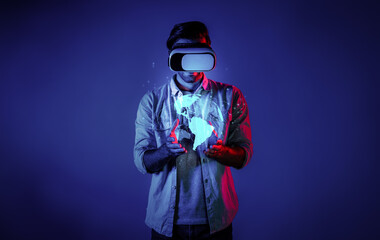 Smart man using VR goggle to connect global network connection. Happy man with casual cloth access futuristic global cloud computing server or software by wearing visual reality headset. Deviation.