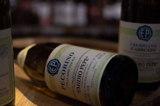 Bottles of Italian vintage wine Pecorino Colli Aprutini IGT Emidio Pepe close-up on oak cask. Ukraine, Zhytomyr, August, 21, 2024