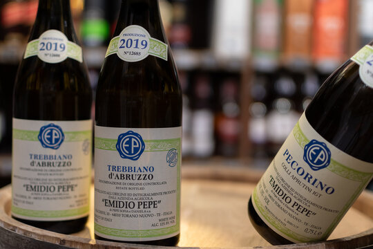 Bottles of Italian vintage wine Pecorino d'Abruzzo Colli Aprutini IGT Emidio Pepe close-up on oak cask. Ukraine, Zhytomyr, August, 21, 2024