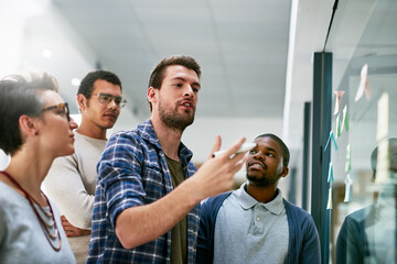 Glass, discussion and sticky notes for ideas, smile and collaboration for brainstorming, creative...