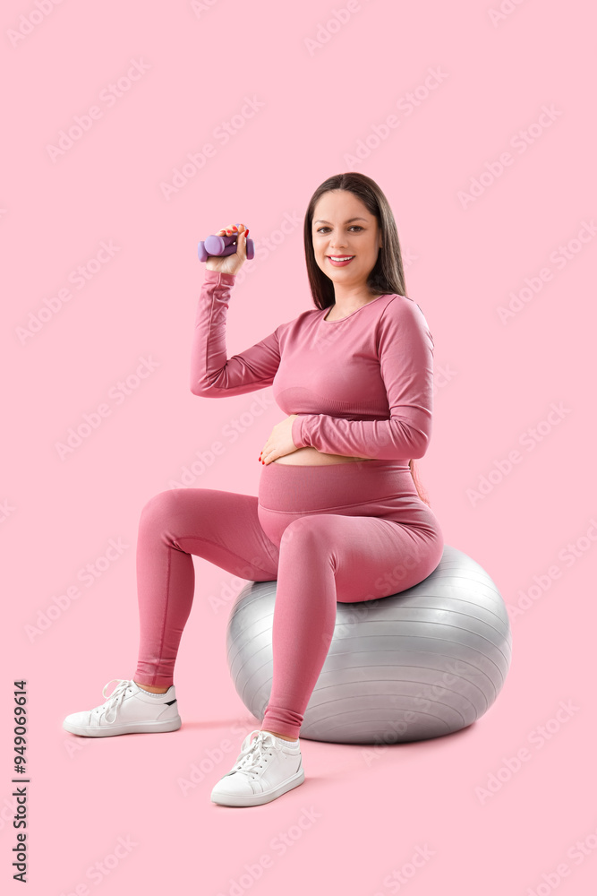 Sticker sporty pregnant woman with dumbbell training on fitball against pink background