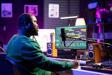 Talented famous composer writes down new verses and lyrics in home studio, composing new music with...