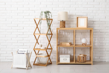 Shelving units near white brick wall