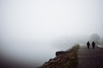 person walking on a foggy morning