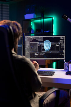 Programmer updating artificial intelligence neural networks, writing binary code scripts. Freelancing system administrator upgrading high tech AI in neon illuminated home