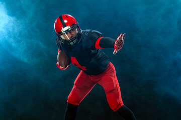 American football player, athlete sportsman in red helmet on stadium background. Sport and...