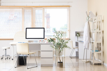 Light interior of doctor's office with modern workplace