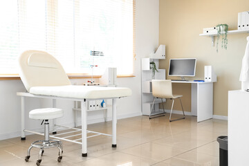 Light interior of doctor's office with modern workplace and couch
