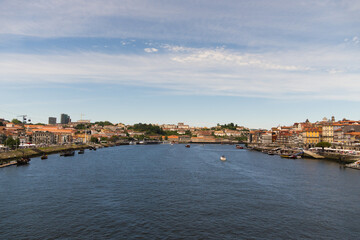 View of Porto city and Douro river and Dom Luis bridge. Porto, Vila Nova de Gaia, Portugal. Cityscape along the river